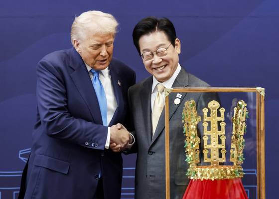 이재명 대통령이 지난달 29일 2025 APEC 정상회의를 계기로 국빈 방문한 도널드 트럼프 미국 대통령에게 ‘천마총 금관 모형’을 선물한 뒤 악수하고 있다. 연합뉴스