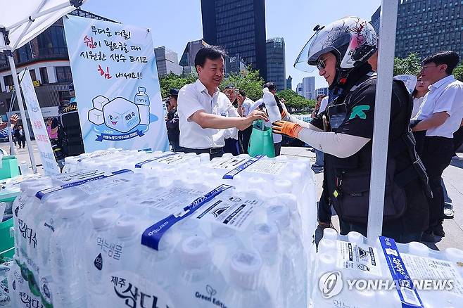 '이동노동자를 위한 시원한 생수 한 병' (서울=연합뉴스) 서대연 기자 = 11일 서울 중구 청계천 장통교 일대에서 '이동노동자를 위한 생수 나눔 캠페인'이 열리고 있다. 2025.6.11 dwise@yna.co.kr