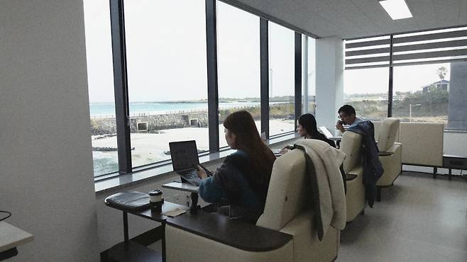 해안 앞 워케이션 데스크에서 오전 업무를 시작한 일본 팸투어 참가자들. (제주관광공사 제공)