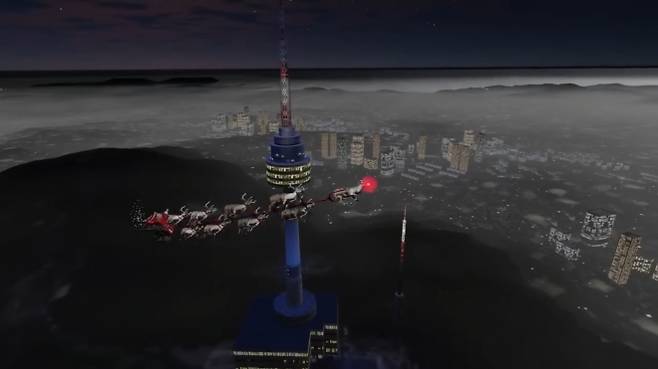 북미항공우주방위사령부(NORAD)가 24일 올린 ‘산타추적’ 페이스북 영상에서 산타가 썰매를 타고 서울 남산타워 상공을 지나고 있다. NORAD 산타추적 페이스북 캡처