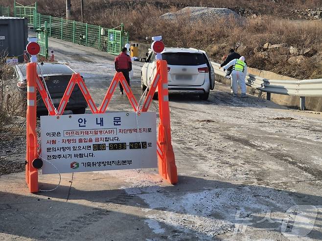 지난 17일 아프리카돼지열병(ASF)이 발생한 강원 강릉시 강동면의 한 양돈농가 앞에서 출입 차량을 대상으로 소독작업을 실시하고 있는 강릉시 방역당국 관계자. (뉴스1 DB) ⓒ News1 윤왕근 기자