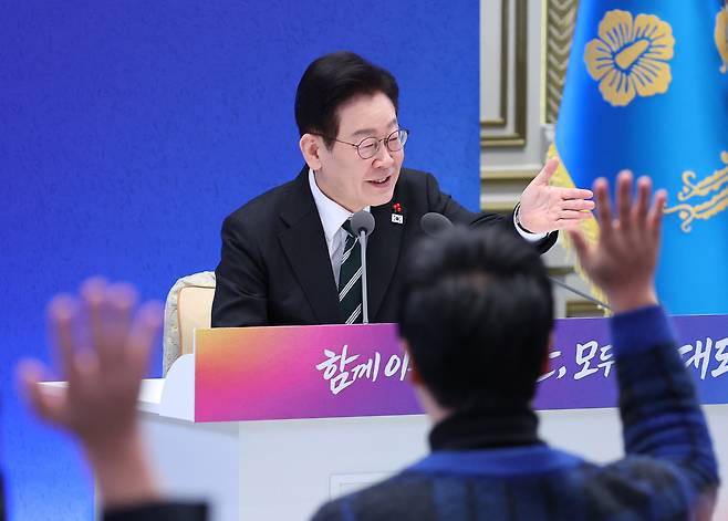 President Lee Jae Myung takes questions from reporters during a New Year’s news conference at Cheong Wa Dae in Seoul, Wednesday. (Yonhap)
