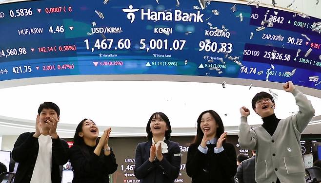 코스피 5000 시대가 열린 22일 오전 서울 중구 하나은행 딜링룸에서 관계자들이 코스피 5000 돌파를 축하하고 있다. 코스피는 전 거래일(4909.93)보다 77.13포인트(1.57%) 상승한 4987.06에 개장했다. 2026.01.22. 뉴시스