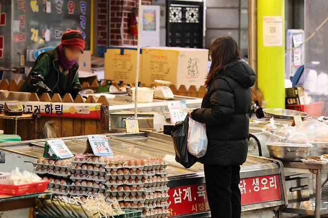 서울 시내의 한 전통시장에서 소상공인이 손님과 대화하고 있다. 연합뉴스