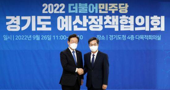 김동연 경기도지사(오른쪽)가 2022년 9월 도청에서 열린 ‘경기도-더불어민주당 예산정책협의회’에서 당시 이재명 대표와 악수하고 있다. 이 자리에선 지역화폐 발행 국비 반영 등이 논의됐다. 경기도 제공