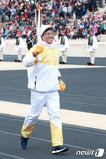 2017년 10월 31일(현지시각) 그리스 아테네에서 열린 '2018 평창동계올림픽 성화 인수식'에서 우리나라 첫 동계올림픽 금메달리스트(쇼트트랙)인 김기훈 울산과학대 교수가 성화를 들고 달리고 있는 모습. (평창조직위) ⓒ 뉴스1 DB