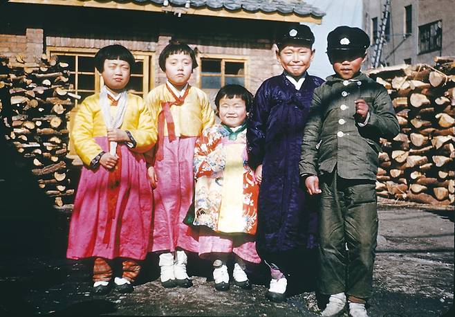 1948년 음력 설을 앞두고 설빔을 입은 소녀들과 교모를 쓴 소년들이 모여 기념사진 포즈를 취하고 있다./ 눈빛 아카이브