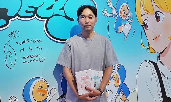 드라마로도 제작된 인기 웹툰 ‘유미의 세포들’의 이동건 작가가 지난 21일 도쿄 한국문화원에서 열린 ‘K웹툰 전시 도쿄’에서 자신의 책을 들어 보이고 있다. 그는 이날 독자와의 대화를 마친 뒤 인터뷰에서 만화 대국 일본 팬들의 관심이 “신기하면서도 짜릿하다”고 소감을 밝혔다. 한국콘텐츠진흥원 제공