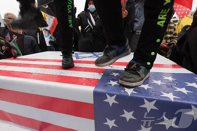 미국-이스라엘 국기 짓밟는 이란 테헤란의 시위대. 2026.03.13 ⓒ 로이터=뉴스1