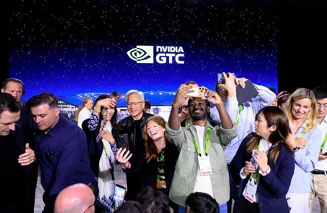 젠슨 황 엔비디아 CEO가 17일(현지시간) 미국 새너제이에서 열린 GTC2026 기자회견이 끝나고 기자들과 셀카를 찍고 있다. AFP연합뉴스