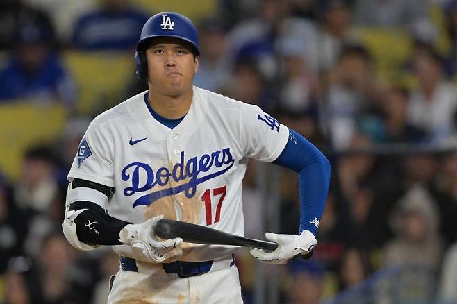 Apr 1, 2026; Los Angeles, California, USA; Los Angeles Dodgers two-way player Shohei Ohtani (17) reacts after he was called out on a checked swing with bases loaded to end in the eighth inning against the Cleveland Guardians at Dodger Stadium. AP연합뉴스