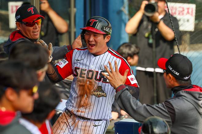 LG 오지환이 12일 잠실 SSG전 득점 후 더그아웃에서 하이파이브하고 있다. LG 트윈스 제공