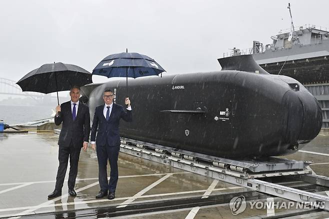 호주, 1조5천억 투입해 대형 정찰·공격용 수중드론 도입 작년 9월 10일(현지시간) 호주 시드니에서 공개된 대형 무인잠수정(UUV) '고스트 샤크' 시제품 앞에 리처드 말스 호주 부총리 겸 국방부 장관(왼쪽)과 패트 콘로이 호주 방위사업부 장관이 서 있다.