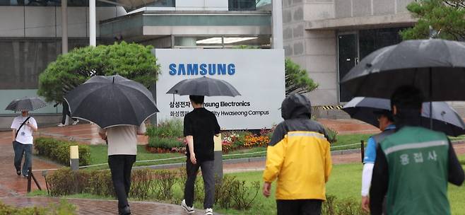 전국삼성전자노동조합이 8일 경기도 화성시 삼성전자 화성사업장 앞에서 1차 총파업 결의대회를 진행한 가운데 입구에서 직원들이 출근하고 있다./2024.7.8 사진=한경 김범준 기자