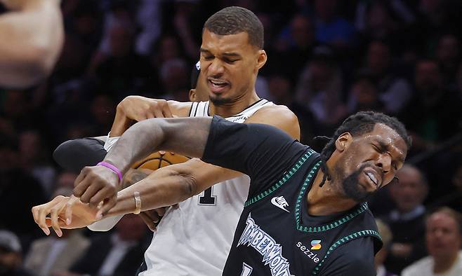 May 10, 2026; Minneapolis, Minnesota, USA; San Antonio Spurs center Victor Wembanyama (1) commits a level two flagrant foul against Minnesota Timberwolves center Naz Reid (11) in the second quarter of game four of the second round of the 2026 NBA Playoffs at Target Center. Wembanyama had to leave the game. Mandatory Credit: Bruce Kluckhohn-Imagn Images