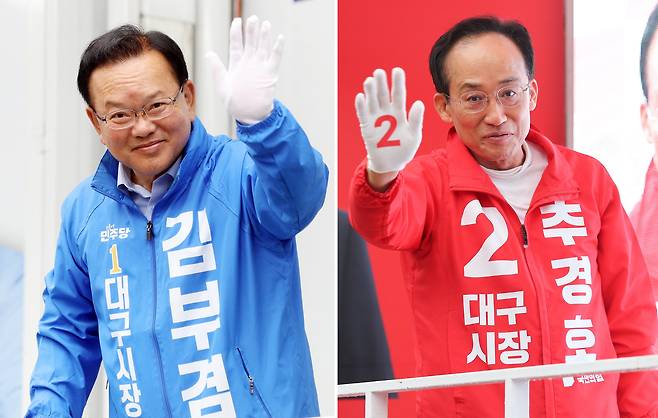 더불어민주당 김부겸 대구시장 후보(왼쪽)와 국민의힘 추경호 대구시장 후보가 21일 대구 범어네거리와 반월당사거리에서 출근길 인사를 하고 있다./연합뉴스