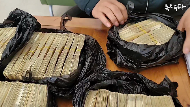 지난 3월 3일, M건설이 모터뱅크 건물 하자보수 비용으로 전달한 현금 3억 원이 검은 봉투에 싸여 있는 모습.