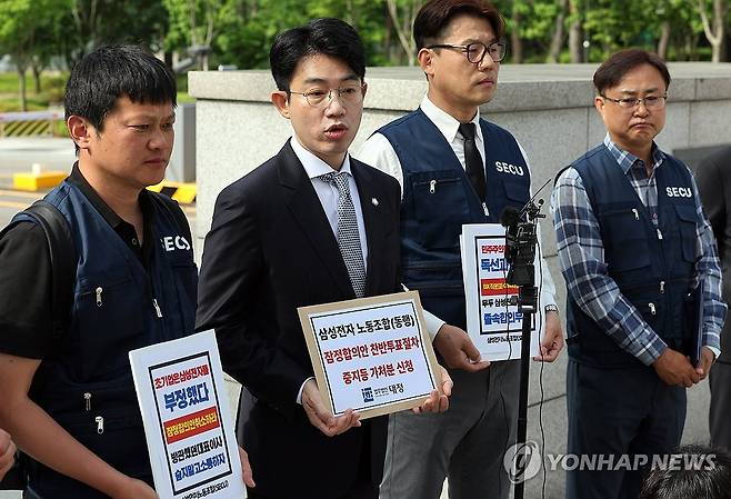 삼전 동행노조, 잠정합의안 투표중지 가처분 신청 (수원=연합뉴스) 권준우 기자 = 26일 오전 경기 수원시 수원지법 청사 앞에서 삼성전자 디바이스경험(DX) 부문 직원들이 주축이 된 삼성전자 노동조합 동행(동행노조) 집행부가 삼성전자 노사 임금협상 잠정합의안 찬반 투표 중지 등 가처분 신청서를 제출하기 전 취재진의 질문에 답하고 있다. 2026.5.26 stop@yna.co.kr