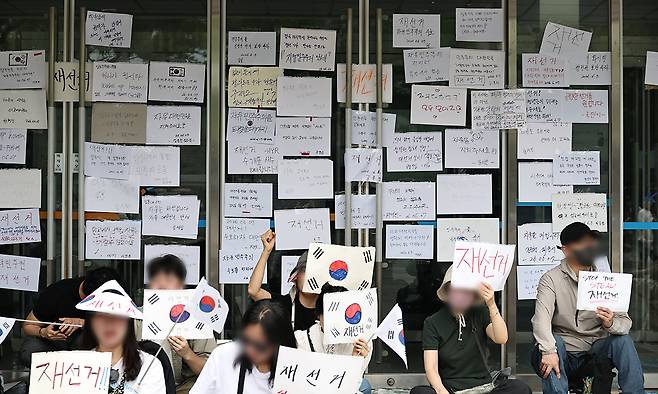 계속되는 '재선거' 외침 (서울=연합뉴스) 김인철 기자 = 6·3 지방선거 투표지 부족 사태를 규탄하며 재선거를 요구하는 '잠실 개표소 봉쇄 시위'가 계속되고 있는 7일 서울 송파구 올림픽공원 핸드볼경기장 출입구에 재선거를 요구하는 문구 등이 적힌 종이가 붙어있다. 2026.6.7 yatoya@yna.co.kr/2026-06-07 12:30:19/ <저작권자 ⓒ 1980-2026 ㈜연합뉴스. 무단 전재 재배포 금지, AI 학습 및 활용 금지>