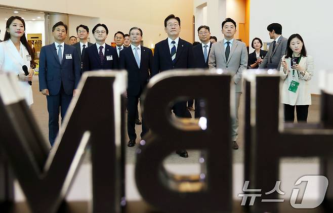이재명 대통령이 30일 광주 김대중 컨벤션센터에서 열린 서남권 첨단산업 발전비전 국민보고회에서 SK하이닉스 AI반도체 전시물을 관람하고 있다. (청와대통신사진기자단) 2026.6.30 ⓒ 뉴스1 이재명 기자