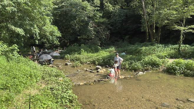 Children catch fish in the waters. WOO JI-WON