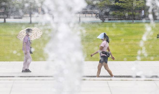 서울 동작구 보라매공원의 시민들이 양산을 쓰고 산책을 하고 있다. 윤창빈 기자