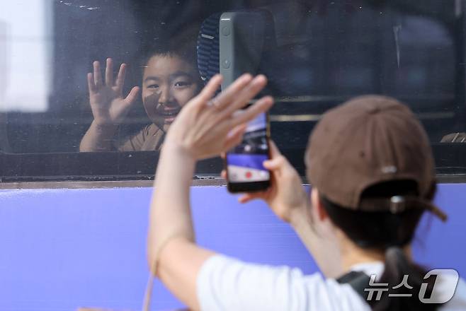 추석 연휴를 하루 앞둔 23일 서울역에서 귀성길에 오른 어린이들이 배웅을 나온 엄마와 인사하고 있다. 2026.9.23 ⓒ 뉴스1 김성진 기자