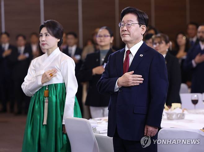 이재명 대통령, 멕시코 동포간담회 (멕시코시티=연합뉴스) 한상균 기자 = 이재명 대통령과 김혜경 여사가 24일(현지시간) 멕시코 한 호텔에서 열린 동포 만찬간담회에서 국기에 경례하고 있다. 2026.9.25 xyz@yna.co.kr