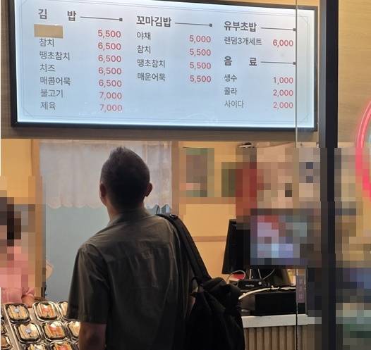 ▲추석 연휴 용산역과 연결된 상업시설의 김밥 매장에서 한 이용객이 메뉴판을 살펴보고 있다. 포장 전문 김밥이 종류에 따라 6000~7000원에 판매되고 있다. 사진=장혜원 기자