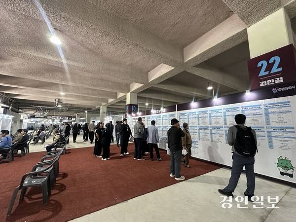 용인미르스타디움에서 열린 ‘2026 하반기 용인시 일자리박람회’에서 구직자들이 참여 기업 안내문을 보고 있다. 2026.10.14 /목은수기자wood@kyeongin.com